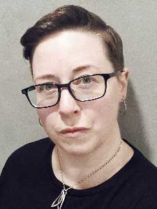 Andrea Zanin in glasses and black top.