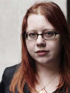 Kate Harrad in square glasses.