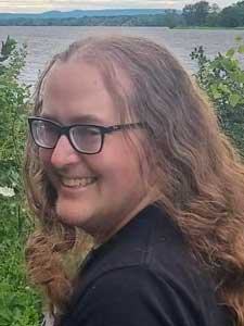 Kayden Abley smiling with lake in background.