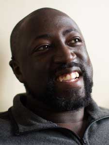 Kevin A. Patterson smiling in a gray shirt.