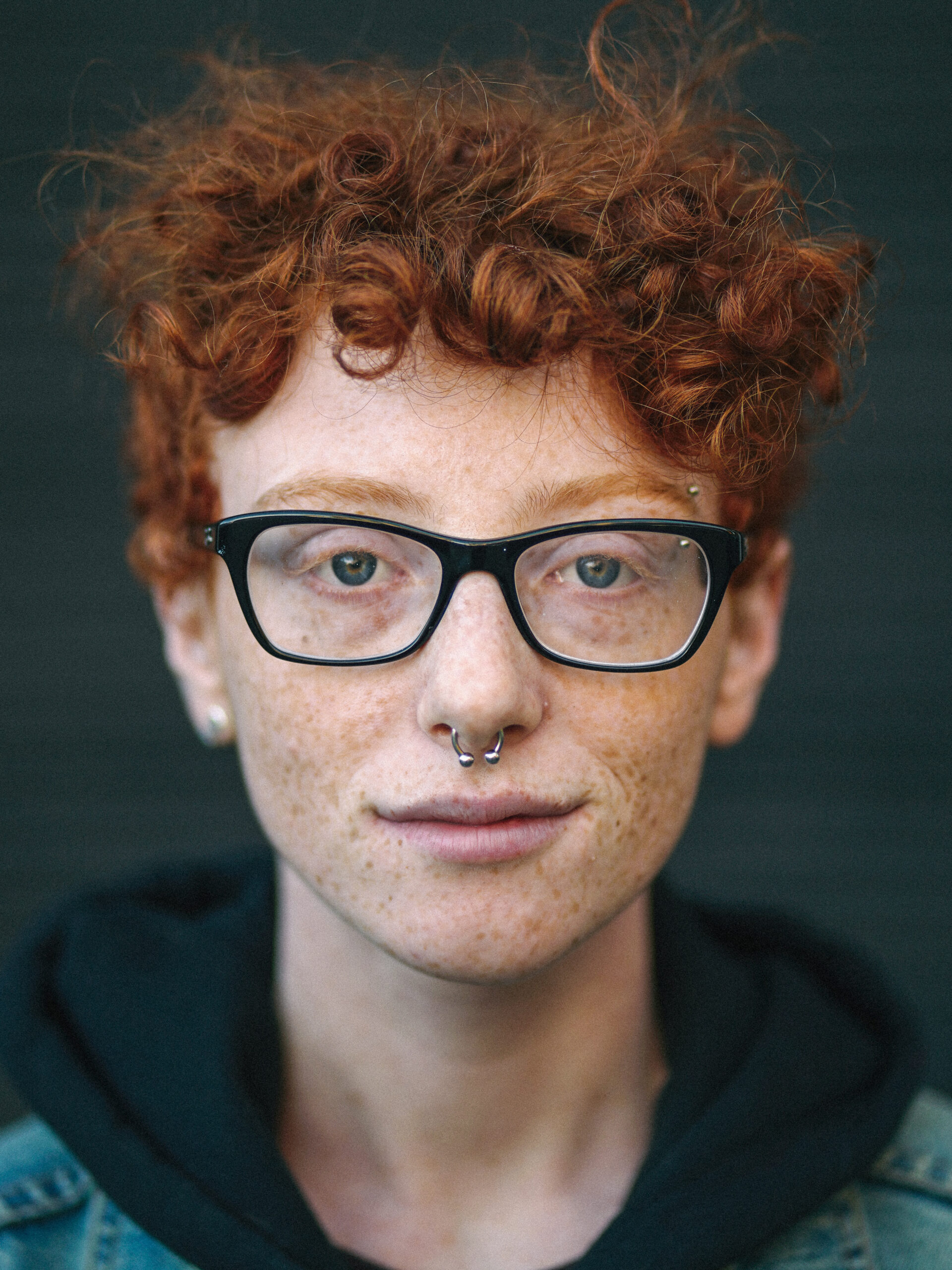 Kay Kassirer in black-framed glasses.