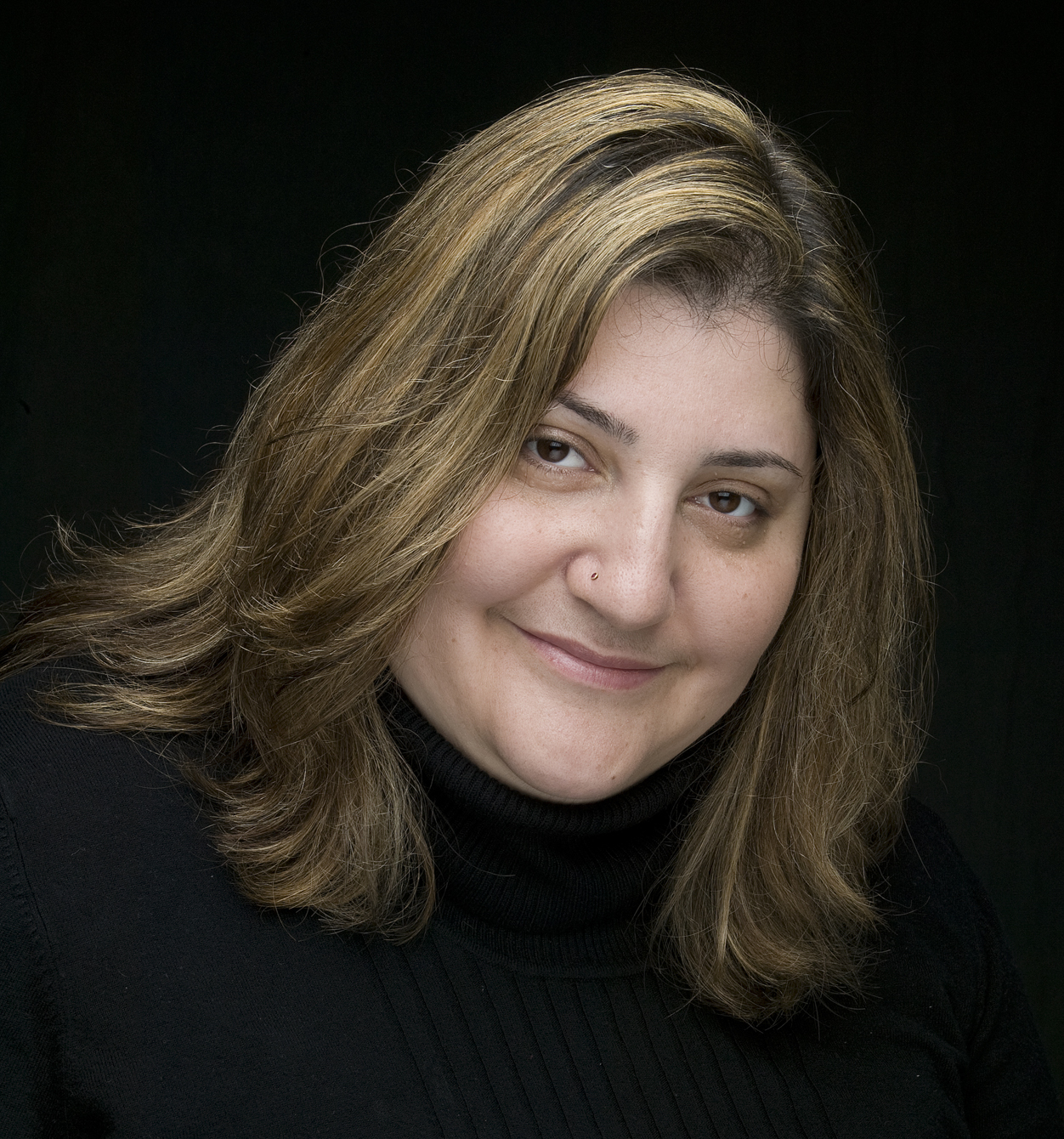 Tamara Pincus smiling in a black sweater.