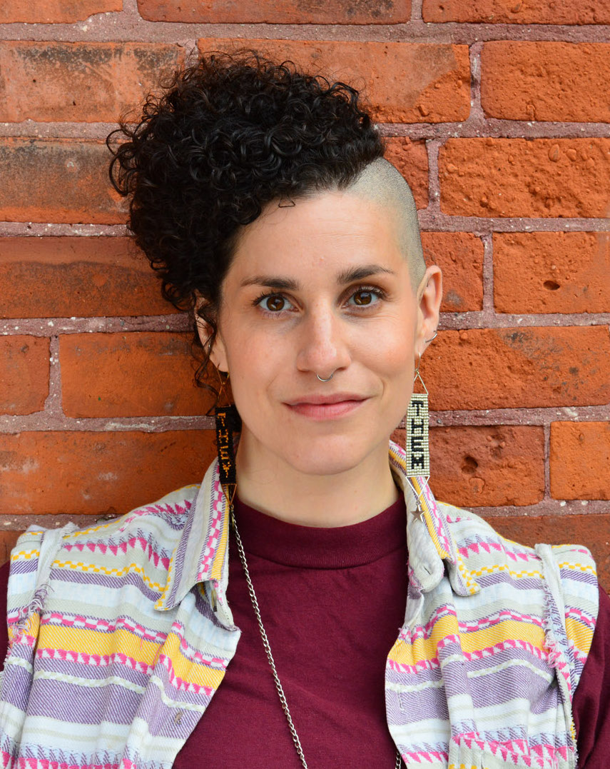 Marla Schreiber, author of Nonmonogamy and Defying a Paradigm, against a brick wall.